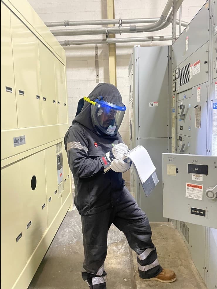 Engineer collecting field data for an arc flash study